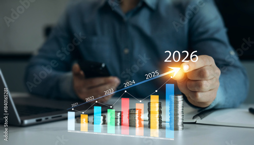 Businessman analyzing financial growth chart for 2026 year.Showing revenue increase, market trends, investment strategy, economic progress, success and future business development in 2026