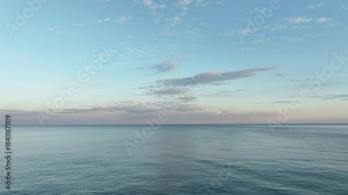 Video flight over ocean, sea on sunrise. Close to the water