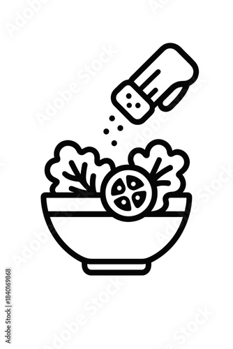 Action of seasoning a healthy salad bowl with fresh ingredients using a shaker