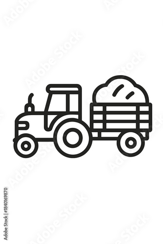Heavy agricultural machinery tractor pulling farm trailer loaded with harvested crops