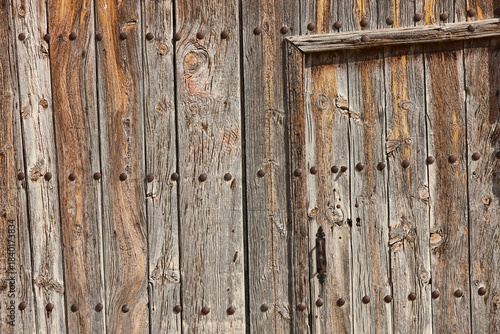 Rusty aged wooden door. Old fashioned gate. Textured background