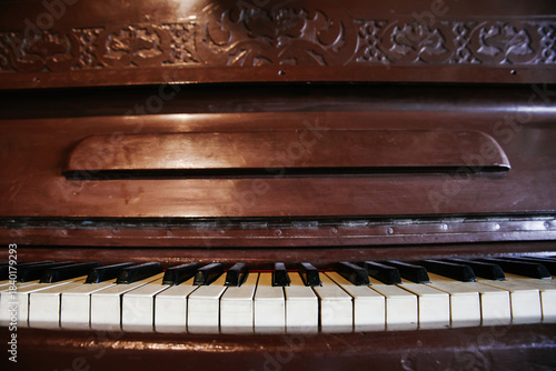 Photography Front-on Close-up of Vintage Upright Piano Keys and the Dark Brown Wood Case wit