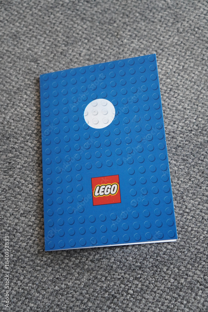 Obraz premium Lego-themed notebook on a gray carpet background, perfect for creative writing