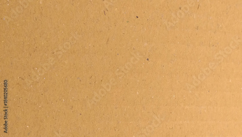 a brown cardboard surface with a characteristic texture. Kraft paper texture background material.