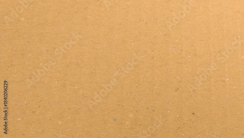 a brown cardboard surface with a characteristic texture. The brown tone is warm and natural, reflecting a simple and eco-friendly material.
