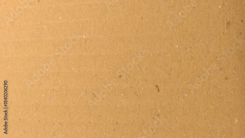 a brown cardboard surface with a characteristic texture. The brown tone is warm and natural, reflecting a simple and eco-friendly material.

