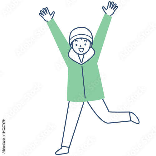 冬の上着を着てジャンプする笑顔の男の子