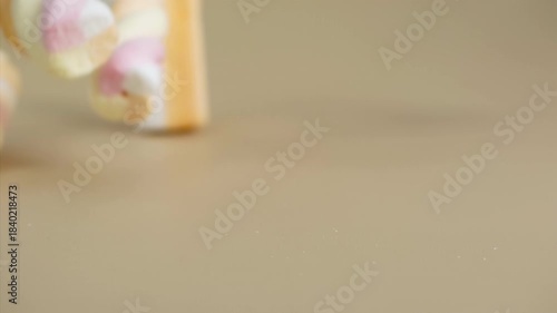 Marshmallows falling on a pastel background . Super slow motion 1000 fps