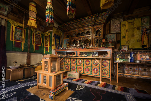 Ogyencholing, Bhutan - 23 September 2025: View of a serene altar adorned with colorful textiles, intricate carvings, and sacred objects, bathed in soft light within the Tang Valley.