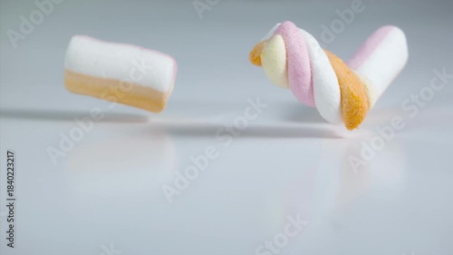 Marshmallows falling on a pastel background . Super slow motion 1000 fps