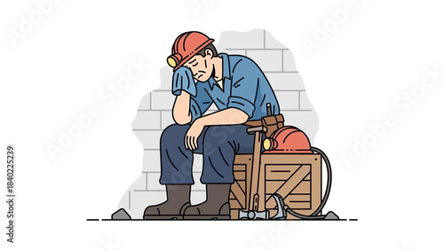 A tired construction worker sits on a crate on a city street, resting and looking worn from a long day of labor.