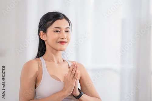 Free Download Young woman practices yoga indoors in a bright space during the morning hours - GFXLoad