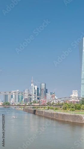 Hyperlapse of Frankfurt skyline featuring the modern ECB headquarters skyscraper with reflective steel-glass facade, train arch bridge and clouds in the blue sky timelapse. Frankfurt am Main, Germany
