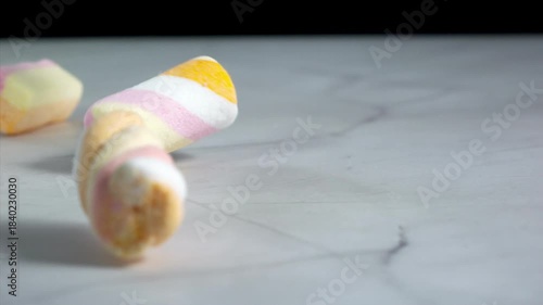 Marshmallows falling on a pastel background . Super slow motion 1000 fps