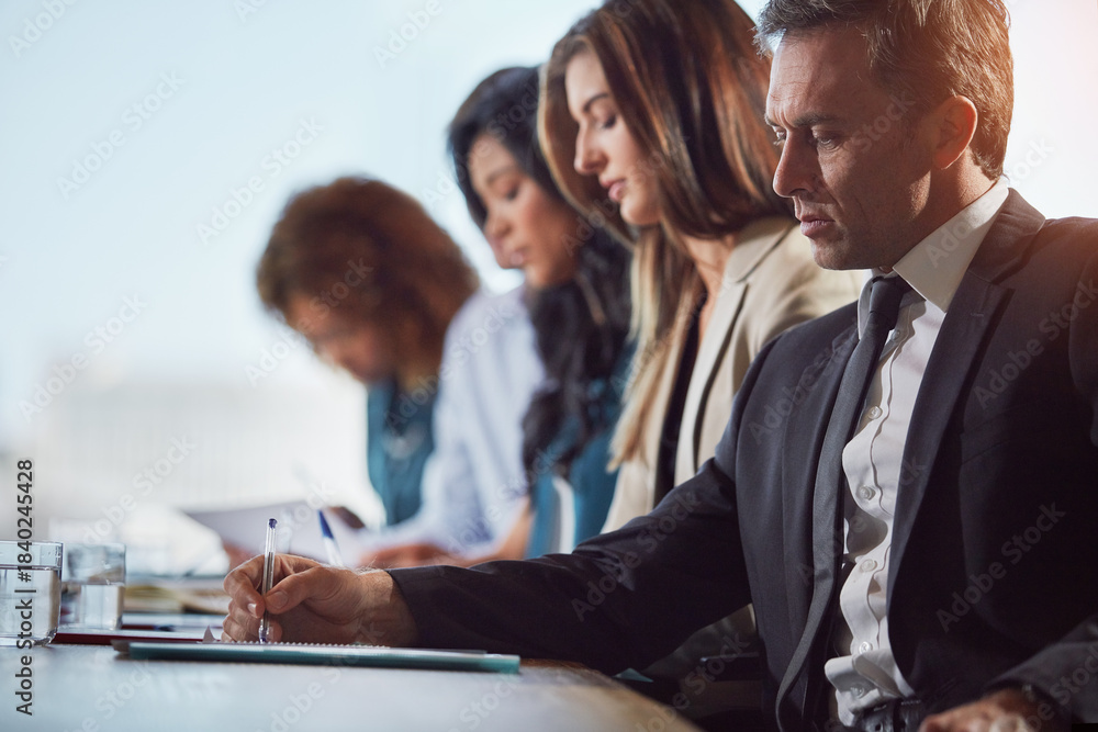 Obraz premium Businessman, writing and team at office meeting with documents, audit or financial review at company. Person, notes and compliance paperwork with group, staff or collaboration at accounting agency