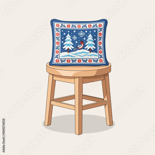 Festive embroidered Christmas pillow with winter scenery on a wooden chair