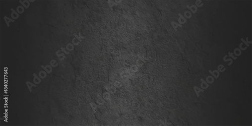 A dark and black grunge background features an old textured stone surface with a vintage gray concrete wall pattern for a rough dirty material backdrop
