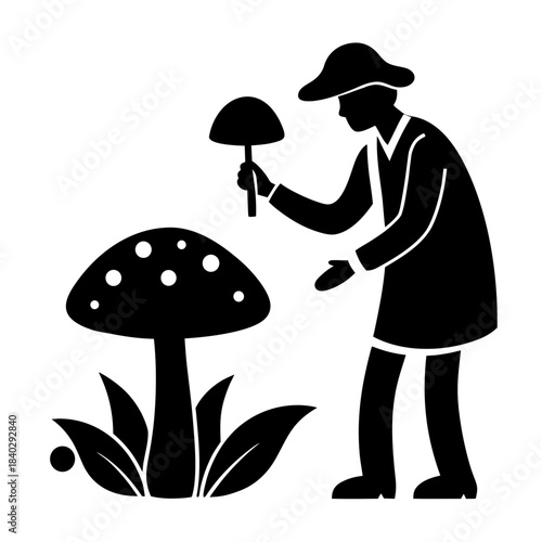 Person picks mushroom near plant during outdoor activity in nature setting