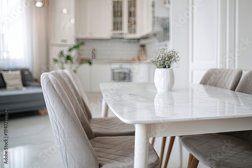 white modern apartment interior, dining room with table and chairs near the kitchen area. scandinavian-style home decor. minimalist design of living space in a white color scheme, 