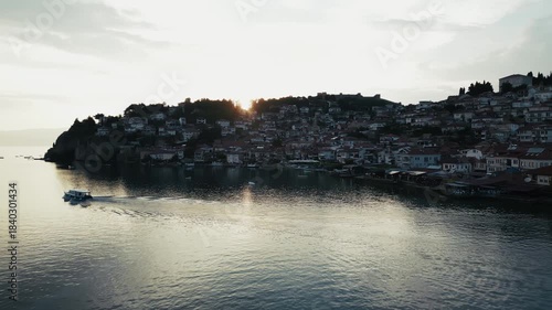 High angle footage of Ohrid Lake and the city on the shore, ferry sailing, 4k