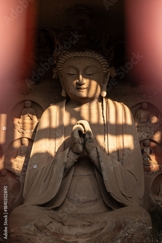 Seated Buddha Statue with Dappled Sunlight at Tapo Cliff Carvings in Anyue China
