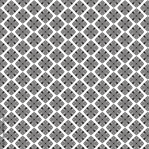 Intricate black and white geometric pattern with repeating floral motifs on a textured background