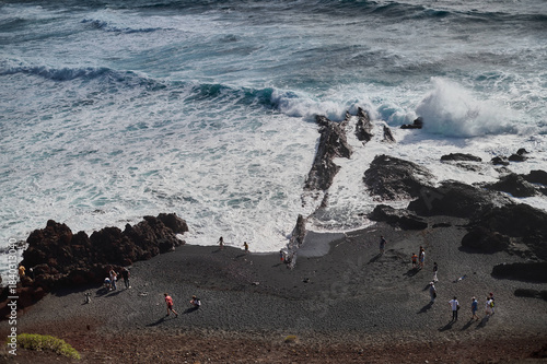Striking green lagoon, Charco de los Clicos or Charco Verde, volcanic crater lake next to the black sand beach, Lanzarote