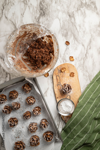 Individual, pinecone desserts made of brownies and whipped cream cheese sprinkled with powdered sugar for a festive forest nature theme.