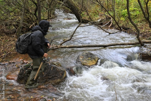 a fisherman on the river with a fishing rod