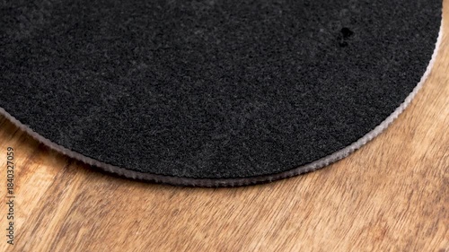 Round clean filters with black fibrous texture on wooden countertop. Water purification system spare part