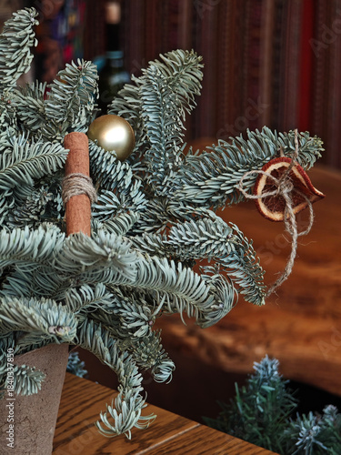 Festive interior decor with decorated Christmas trees in warm public setting.