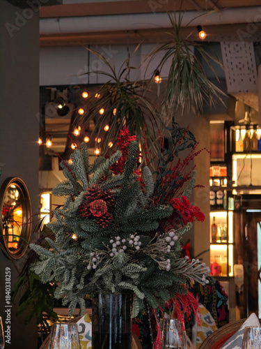 Festive interior decor with decorated Christmas trees in warm public setting.