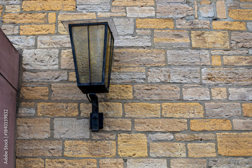 turned-off street lamp on an old brick wall. Traveling to Europe.