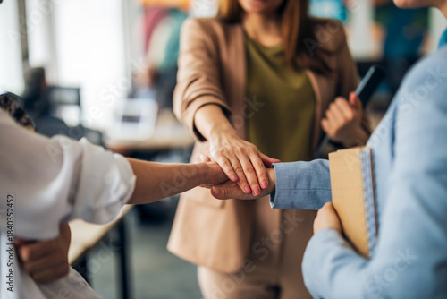 Team Members Joining Hands to Symbolize Collaboration and Unity