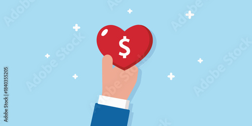 A hand holding a red heart with a dollar sign inside it