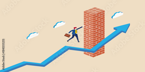A businessman climbs a brick wall atop an upward trending graph