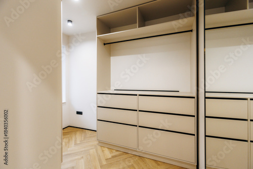 Photography Ample closet featuring personalized storage and elegant neutral tones