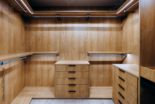 Luxurious dressing room featuring custom shelving and refined finishes