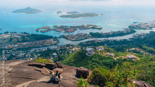 Tableau sur toile Friends enjoying a panoramic overlook of tropical coast, islands, and village be