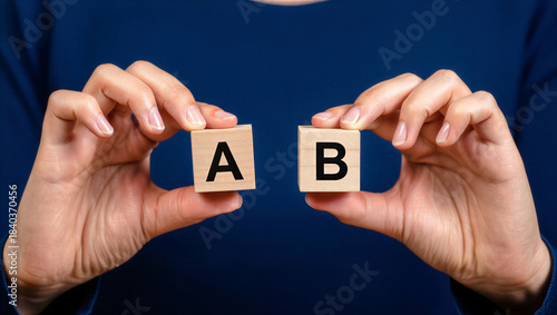 A/B Testing Concept: Hands Holding Wooden Blocks A and B for Business Analysis, Marketing Strategy, Comparison & Decision Making
