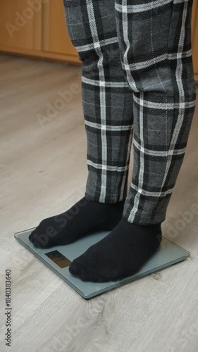 Feet in Black Socks Standing on Digital Bathroom Scales