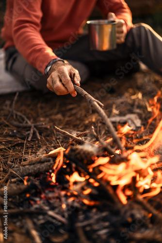 Wallpaper Mural Man Prepares Campfire in Forest with Metal Mug by His Side Torontodigital.ca