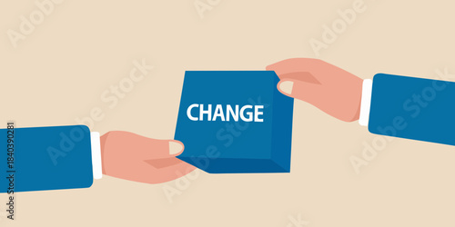 Hands fitting the piece with the word change into a puzzle