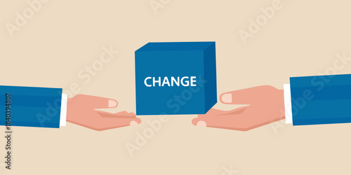 Hands presenting a blue cube with the word change written on it