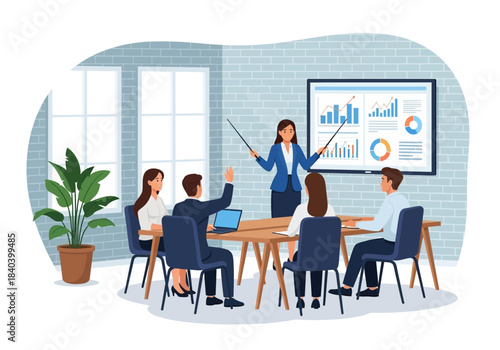 Business meeting presentation with female manager pointing at charts on screen to team members sitting around a wooden table in an office setting with large windows and a potted plant