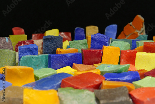 Multi-colored smalt from old Soviet mosaics on black background