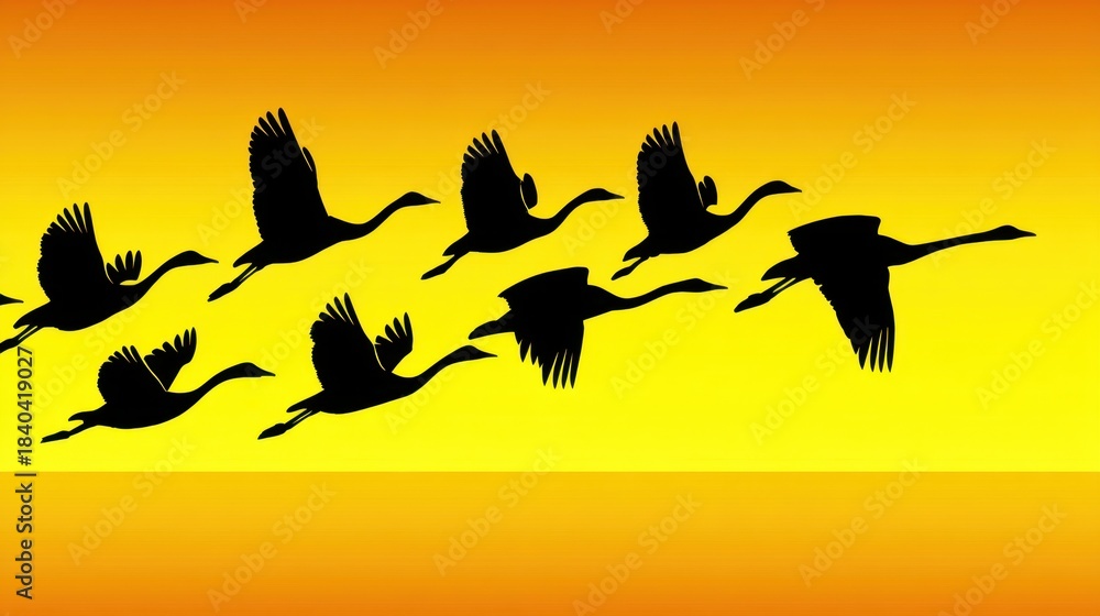 Fototapeta premium Flock of cranes flying in formation across a vibrant sunset sky