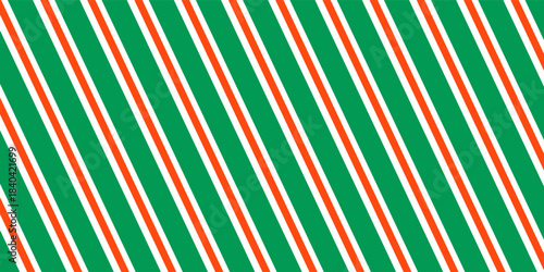 Christmas seamless pattern. Red and green diagonal stripes background. Candy cane repeating decoration wallpaper. Winter holiday lines backdrop. vector