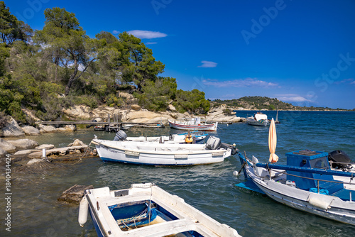 Small fishing boats at wooden pier in Fteroti, Sithonia, Chalkidiki, Greece