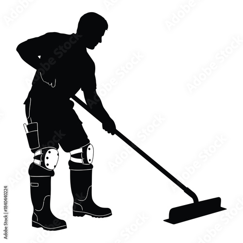 Silhouette of a construction worker or laborer using a longhandled squeegee or floor tool